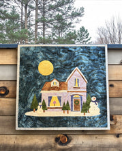 Load image into Gallery viewer, “Completed Cozy Winter Home appliqué wallhanging – pastel house with snowmen and moonlit sky – Laurie Kent Designs quilt pattern.”
